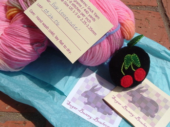pink lemonade sock yarn and a cherry tape measure