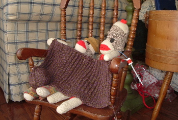 still life with unfinished vest and sock monkeys