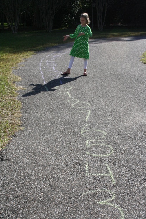 Demonstrating 3 x 4 = 12 on out MASSIVE number line that goes all around the driveway.