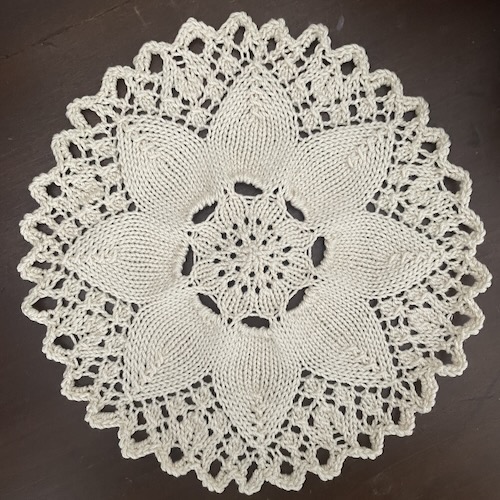 a flower doily in off-white yarn